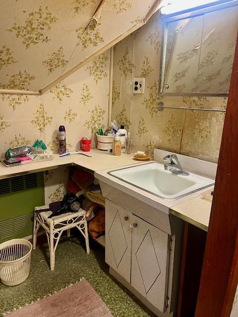 bathroom featuring wallpapered walls and vanity