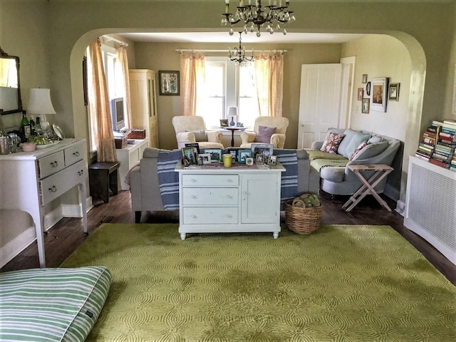 535 Beechwoods Rd, Callicoon, NY 12723 - sitting room with arched walkways, wood finished floors, a chandelier, and baseboards