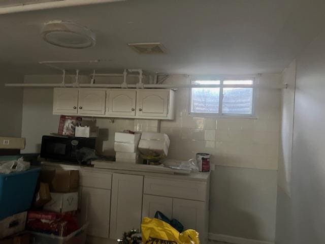 20-25 Parsons Blvd, Whitestone, NY 11357 - kitchen with white cabinetry, black microwave, and light countertops