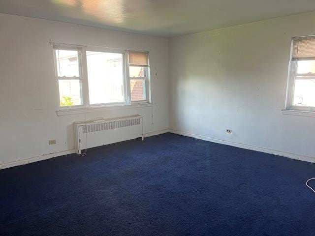 20-25 Parsons Blvd, Whitestone, NY 11357 - empty room featuring radiator, dark carpet, and baseboards