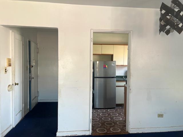 20-25 Parsons Blvd, Whitestone, NY 11357 - kitchen with freestanding refrigerator and white cabinetry
