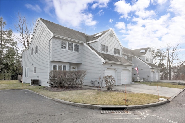 8 Beach Manor Ct, West Islip, NY 11795 - view of front of home with central AC, a front yard, a shingled roof, a garage, and driveway