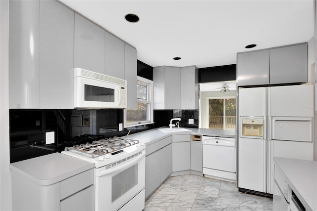 8 Beach Manor Ct, West Islip, NY 11795 - kitchen featuring marble finish floor, a sink, white appliances, and plenty of natural light