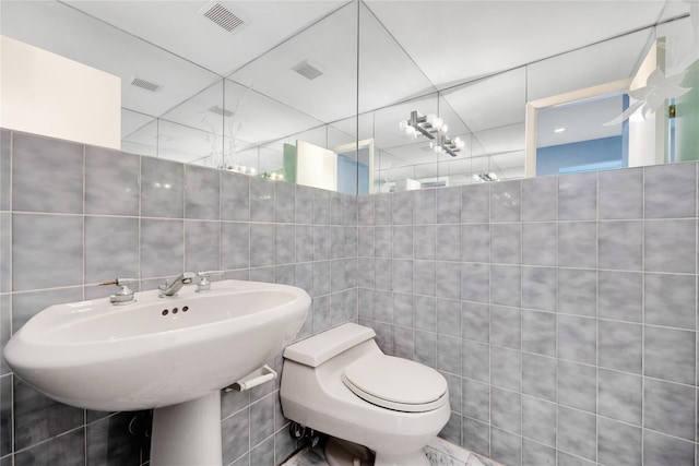 8 Beach Manor Ct, West Islip, NY 11795 - bathroom featuring toilet, visible vents, and tile walls
