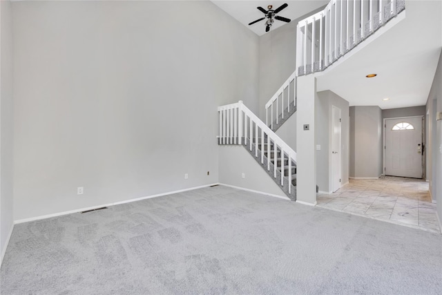 8 Beach Manor Ct, West Islip, NY 11795 - unfurnished living room featuring carpet, a towering ceiling, a ceiling fan, stairway, and baseboards