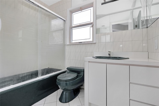 8 Beach Manor Ct, West Islip, NY 11795 - bathroom featuring shower / bath combination with glass door, vanity, toilet, tile walls, and tile patterned floors