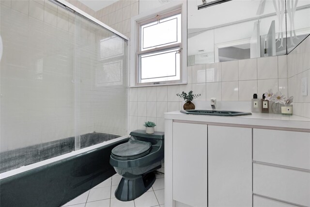 8 Beach Manor Ct, West Islip, NY 11795 - full bathroom with vanity, enclosed tub / shower combo, tile patterned floors, toilet, and tile walls