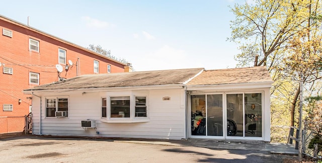 back of property with a shingled roof