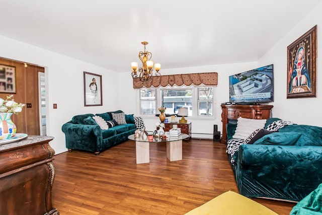 living area with a chandelier, wood finished floors, and a baseboard heating unit