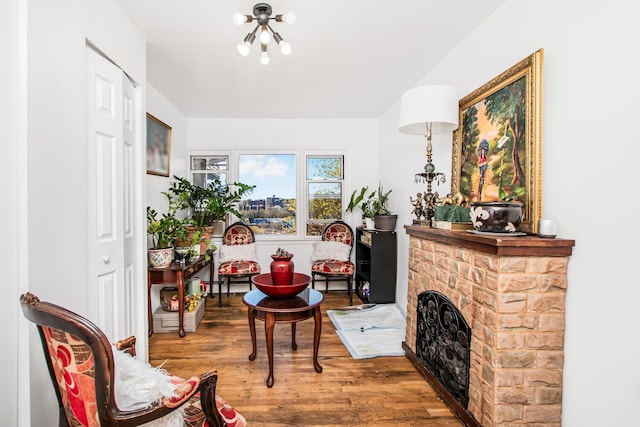 sitting room with an inviting chandelier and wood finished floors