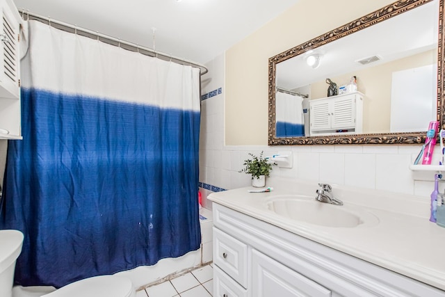bathroom with toilet, tile walls, visible vents, shower / tub combo, and vanity