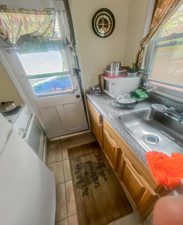 interior space with tile patterned flooring and a sink