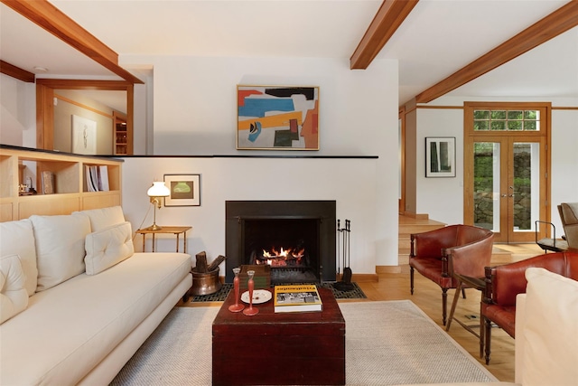 27 Dingle Ridge Rd, North Salem, NY 10560 - living room with beamed ceiling, wood finished floors, french doors, and a fireplace with flush hearth