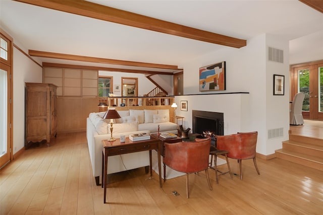 27 Dingle Ridge Rd, North Salem, NY 10560 - living room featuring beamed ceiling, stairway, light wood-style floors, a warm lit fireplace, and baseboards