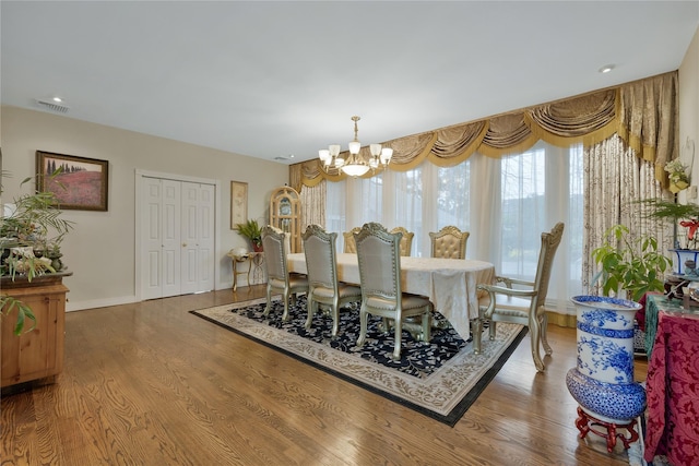 8 Percheron Ln, Roslyn Heights, NY 11577 - dining area featuring wood finished floors, visible vents, a notable chandelier, and baseboards