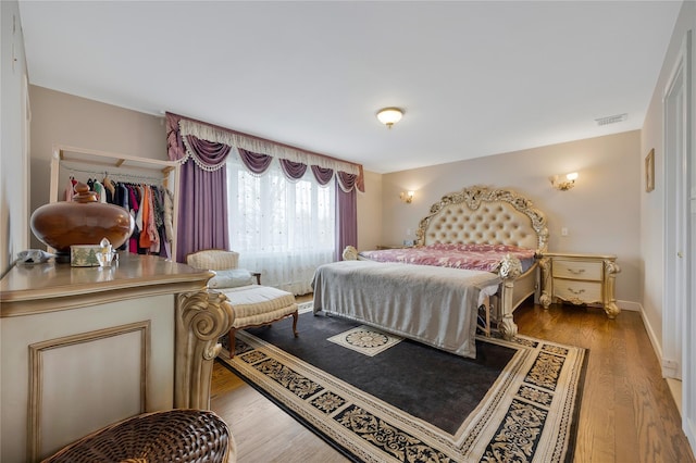 8 Percheron Ln, Roslyn Heights, NY 11577 - bedroom featuring wood finished floors, visible vents, and baseboards