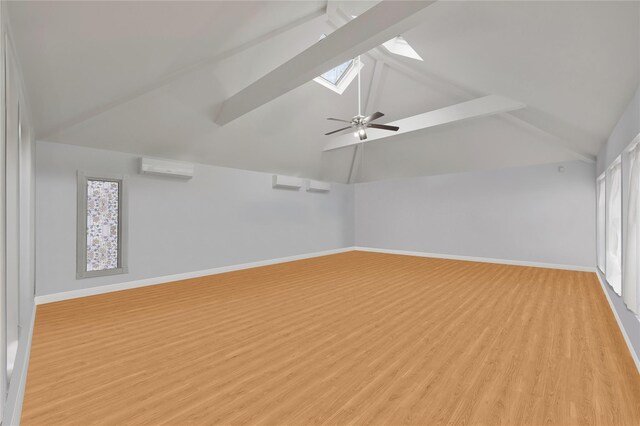 8 Percheron Ln, Roslyn Heights, NY 11577 - bonus room featuring vaulted ceiling with skylight, ceiling fan, light wood-style flooring, baseboards, and an AC wall unit
