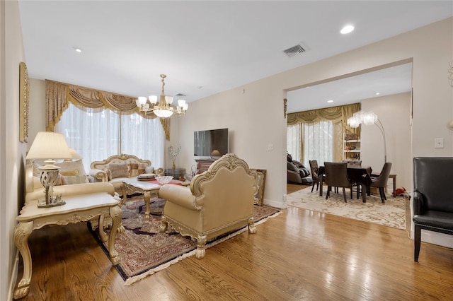 8 Percheron Ln, Roslyn Heights, NY 11577 - living area with an inviting chandelier, wood finished floors, visible vents, and recessed lighting