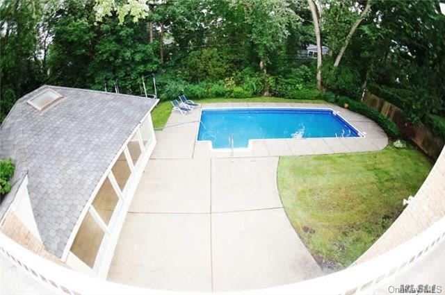 8 Percheron Ln, Roslyn Heights, NY 11577 - view of pool with a fenced in pool and a lawn
