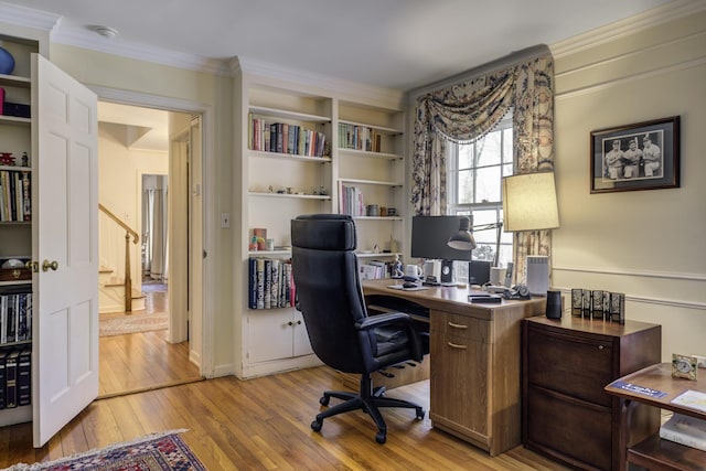 home office featuring light wood-style flooring and ornamental molding