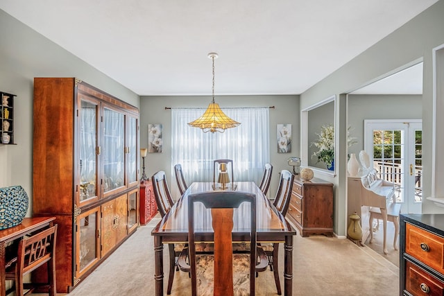dining area with light colored carpet