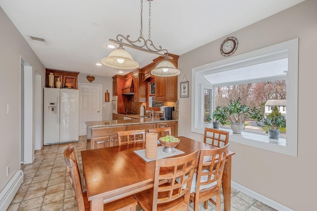 dining space featuring visible vents, baseboards, a baseboard radiator, recessed lighting, and stone tile floors