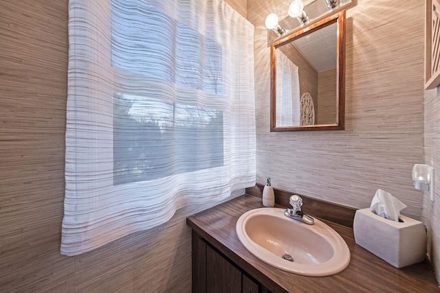 bathroom with vanity and tile walls