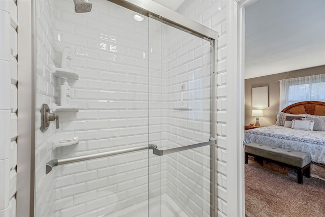 bathroom featuring a shower stall and connected bathroom