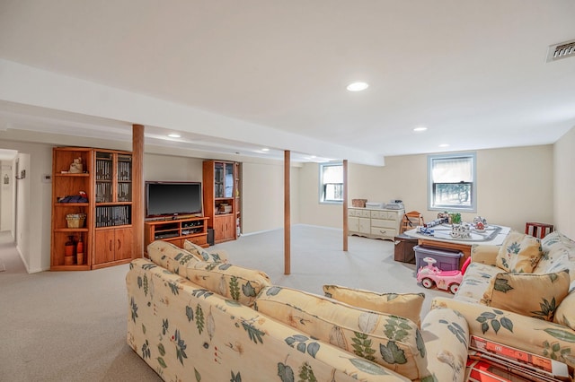 carpeted living area featuring visible vents and recessed lighting