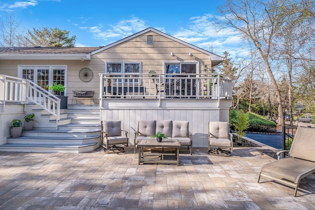 rear view of house with outdoor lounge area, stairway, and a patio