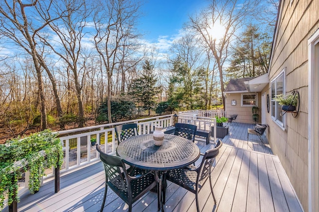 wooden deck featuring outdoor dining area
