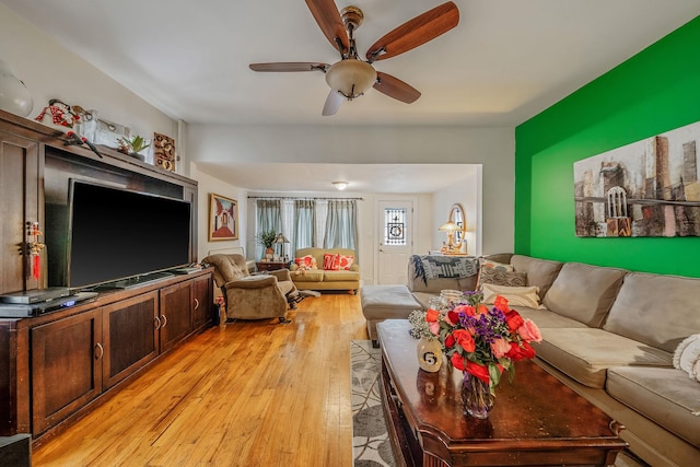 living area featuring light wood-style flooring and ceiling fan