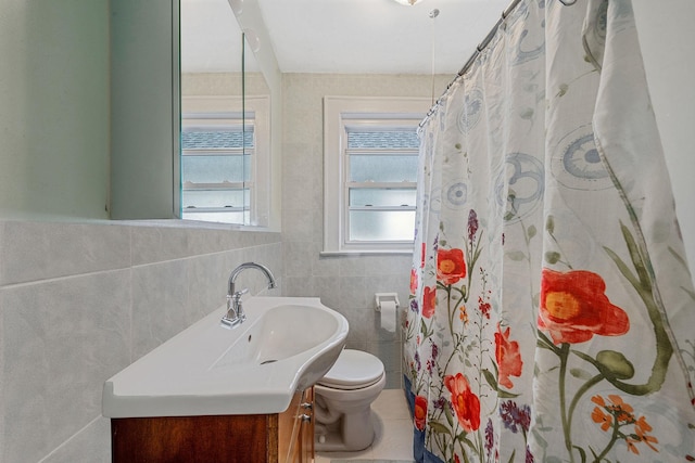 bathroom featuring a shower with shower curtain, tile walls, toilet, and vanity