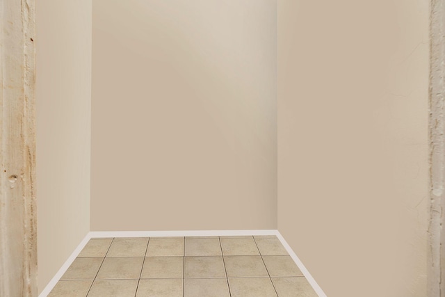 interior space with light tile patterned flooring and baseboards