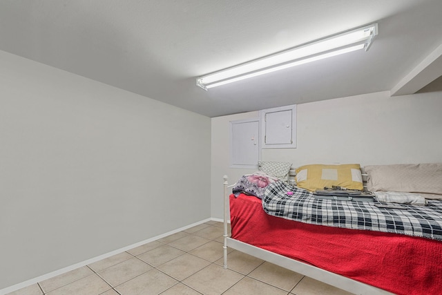 bedroom featuring baseboards and light tile patterned floors