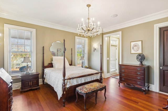 bedroom featuring crown molding, an inviting chandelier, and dark wood finished floors