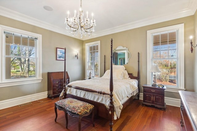 bedroom featuring dark wood-type flooring, crown molding, an inviting chandelier, and visible vents