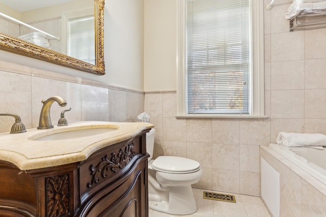 bathroom with tiled tub, visible vents, toilet, tile walls, and tile patterned floors