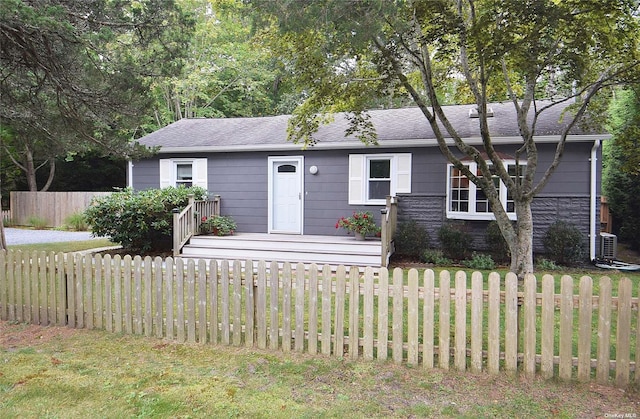 single story home with a shingled roof and fence