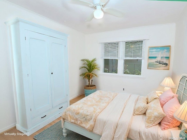 bedroom featuring a closet, baseboards, a ceiling fan, and light wood-style floors