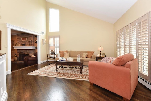 living room featuring baseboard heating, a fireplace, visible vents, high vaulted ceiling, and wood finished floors