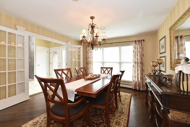dining area featuring dark wood finished floors, wallpapered walls, a baseboard radiator, french doors, and a notable chandelier