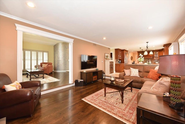 living area featuring crown molding, a notable chandelier, dark wood finished floors, and recessed lighting
