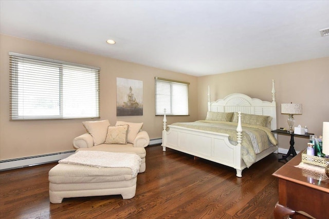 bedroom featuring wood finished floors, a baseboard heating unit, visible vents, and recessed lighting