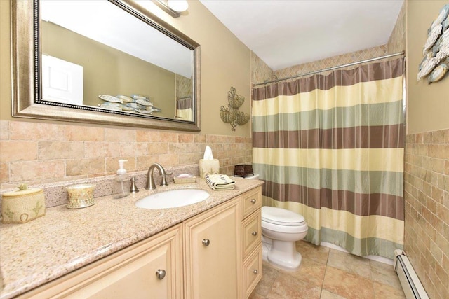 bathroom with vanity, a shower with curtain, baseboard heating, toilet, and tile walls