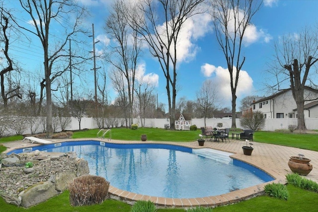 view of swimming pool featuring a diving board, a lawn, a fenced backyard, a patio, and a fenced in pool