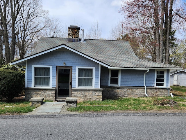 view of front of house featuring a chimney
