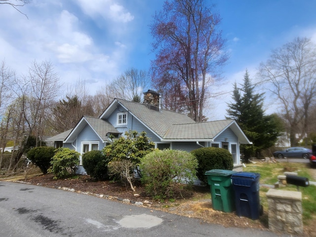view of side of home with a chimney