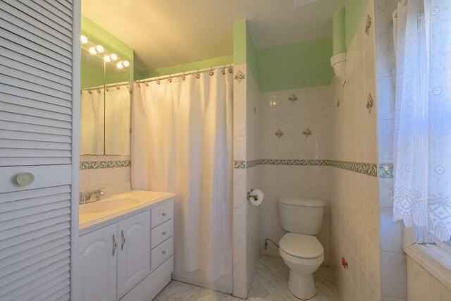 193-21 109th Rd, Saint Albans, NY 11412 - full bathroom with tile walls, vanity, marble finish floor, and toilet