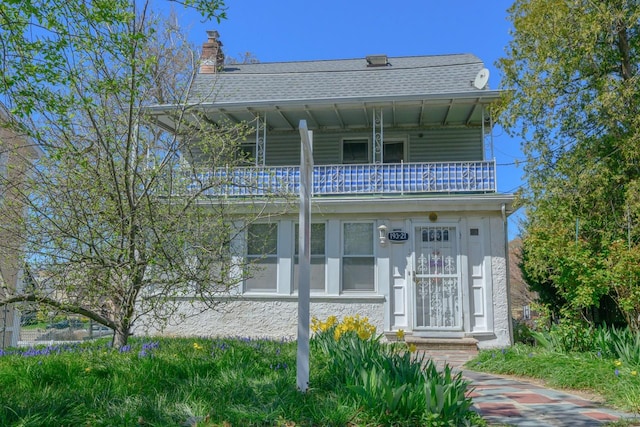 193-21 109th Rd, Saint Albans, NY 11412 - view of front facade featuring a chimney, a balcony, and a shingled roof